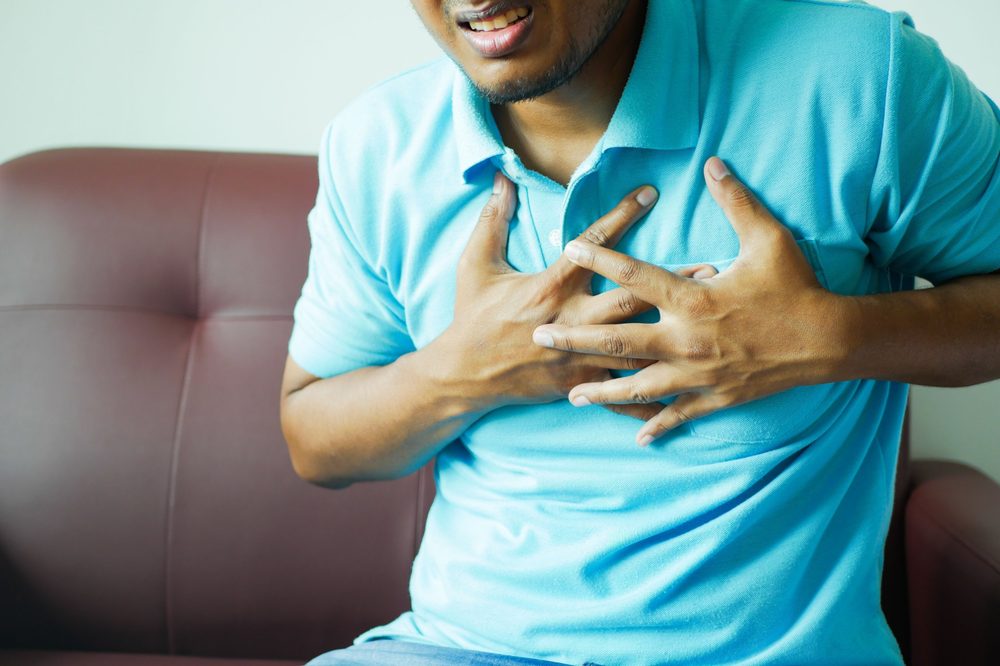 Person holding their chest